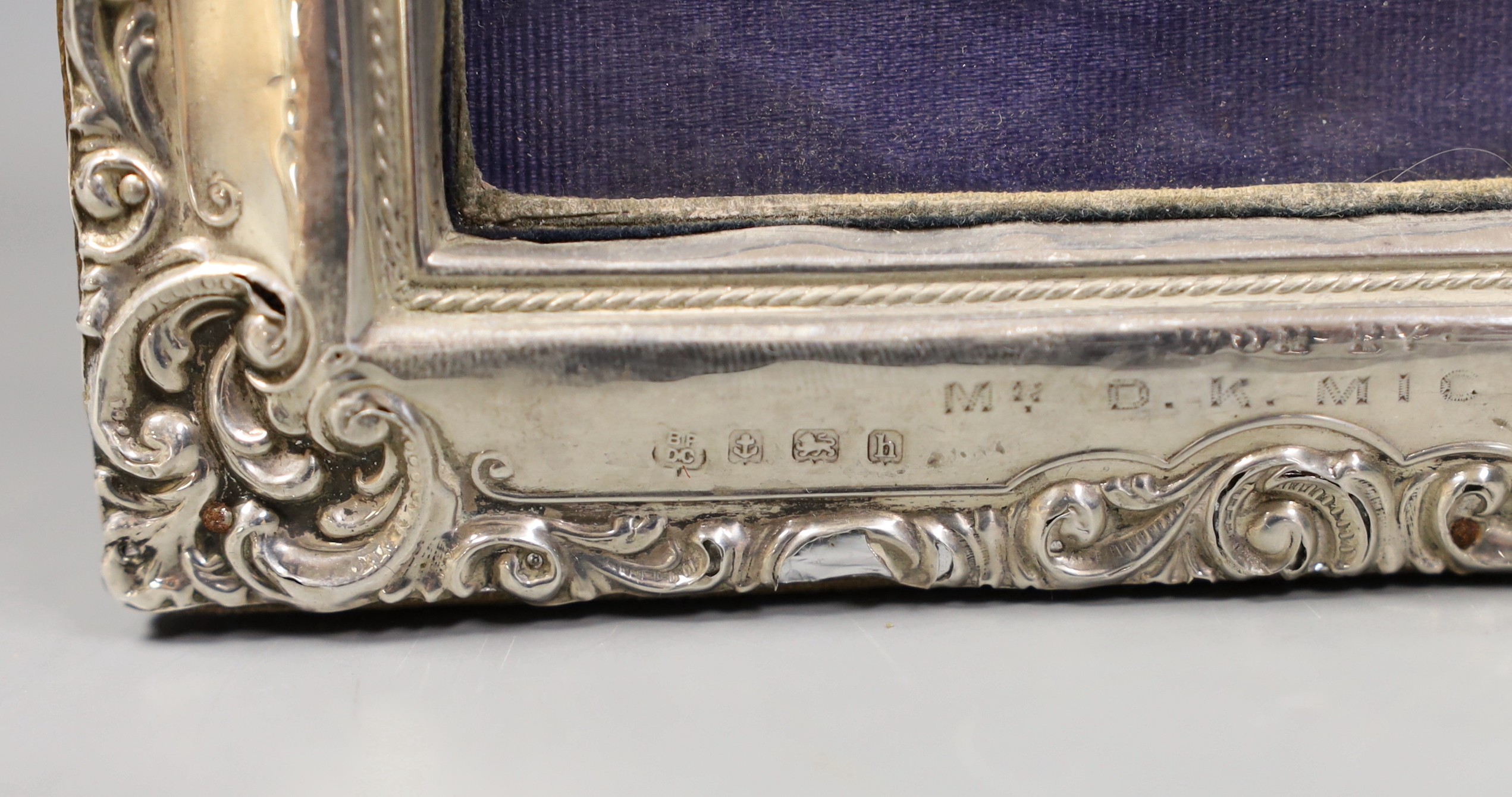 An Edwardian silver mounted photograph frame, with Scottish Match Rifle Association inscription, Boots Pure Drug Company, Birmingham, 1907, 19cm, together with a George V silver mounted capstan inkwell, with Bisley relat